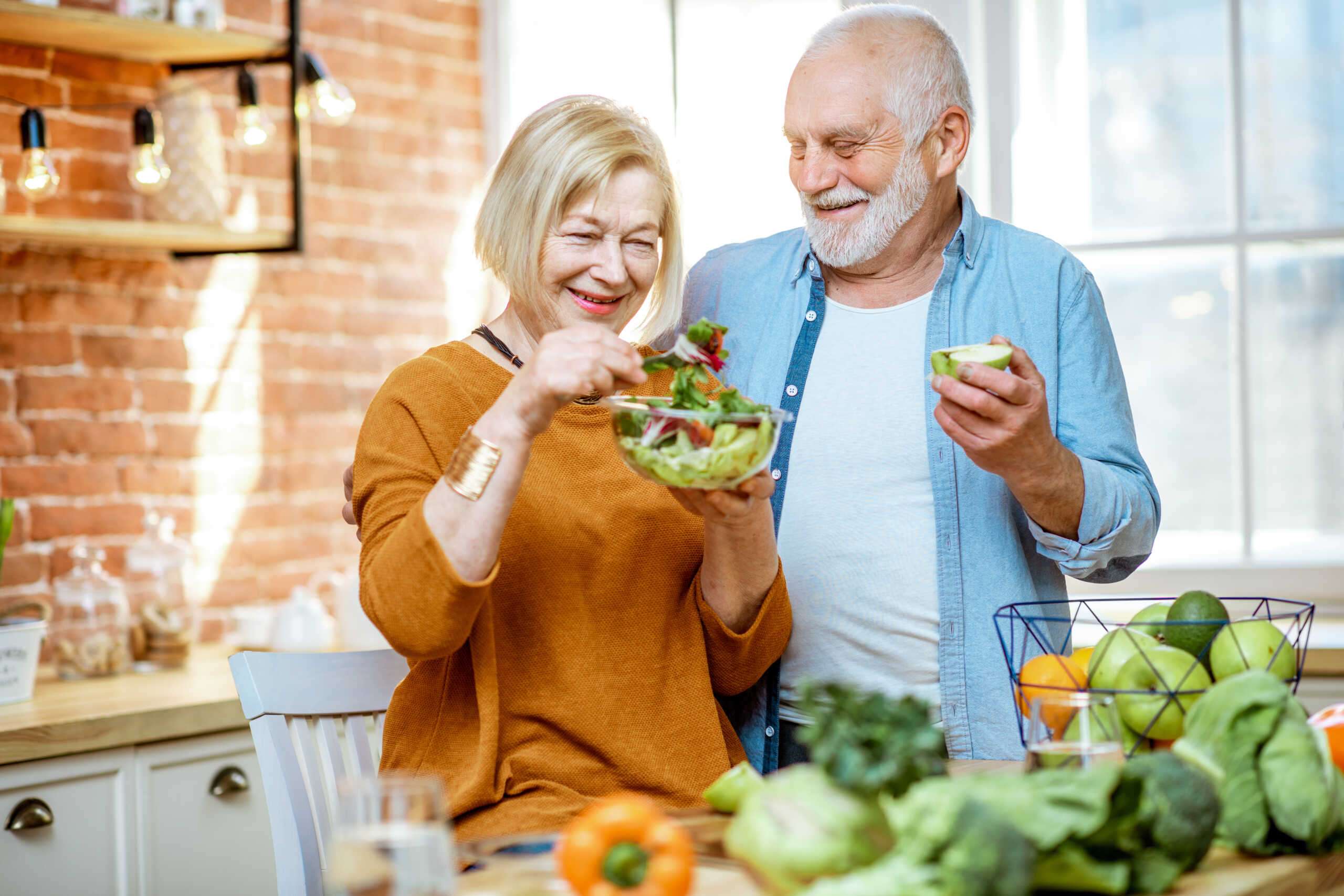 Senior couple with healthy food at home